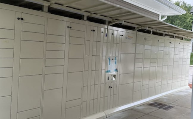Package Nexus parcel locker bank with canopies at a multifamily property. | Package Nexus
